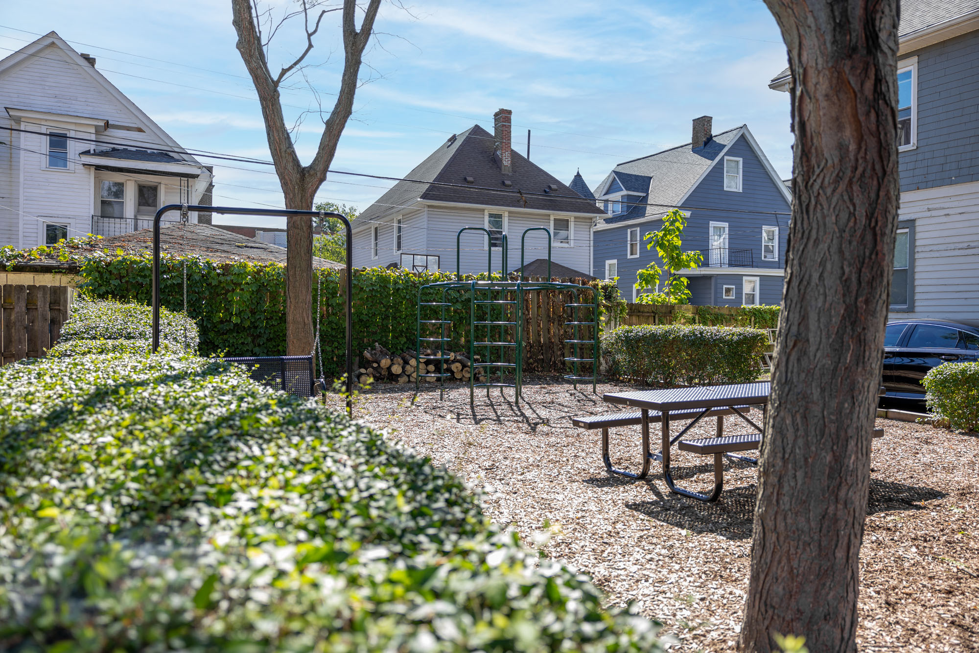 Clifton Prado Park - playground, picnic table, and shade trees.