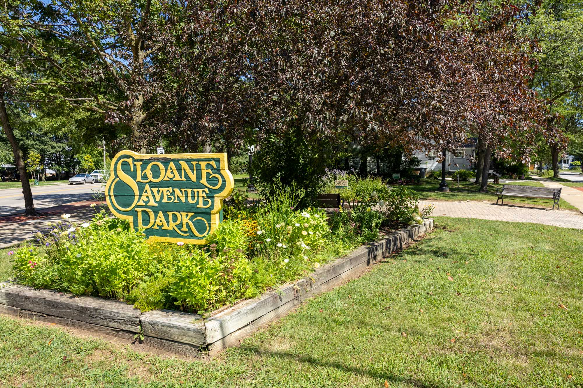 Sloane Avenue Park sign and green space.