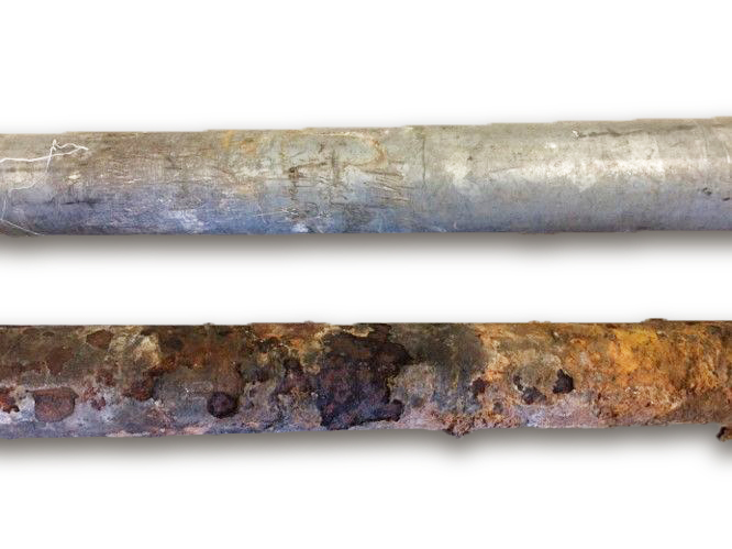 Two old galvanized steel pipes - one cleaner, one rusted.
