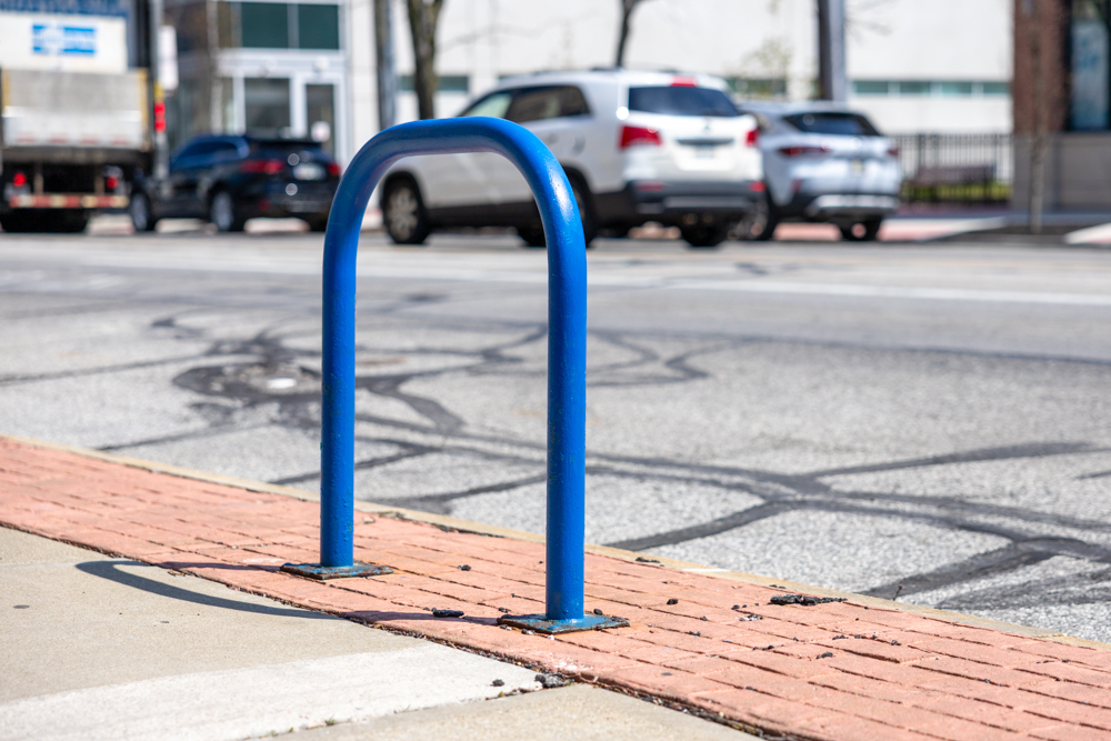 Blue bike rack stationed on Detroit Ave.